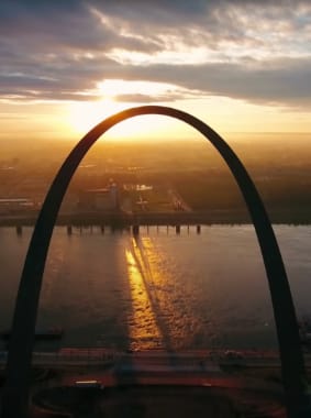 An arch with the sunset behind it